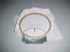 6" hoop with double cut away, marked for the edge of a hat, hole cut for text, and tear away behind hole
